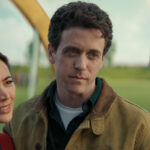 Helen and Daniel Keene stand on the grounds of the silo complex during the Before Times in Silo Season 3 Episode 9, “Farewell.”