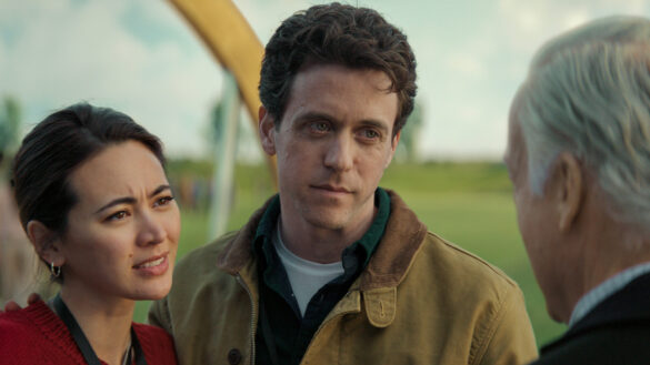 Helen and Daniel Keene stand on the grounds of the silo complex during the Before Times in Silo Season 3 Episode 9, “Farewell.”